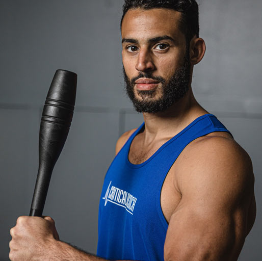 Coach Zach holding Indian Club